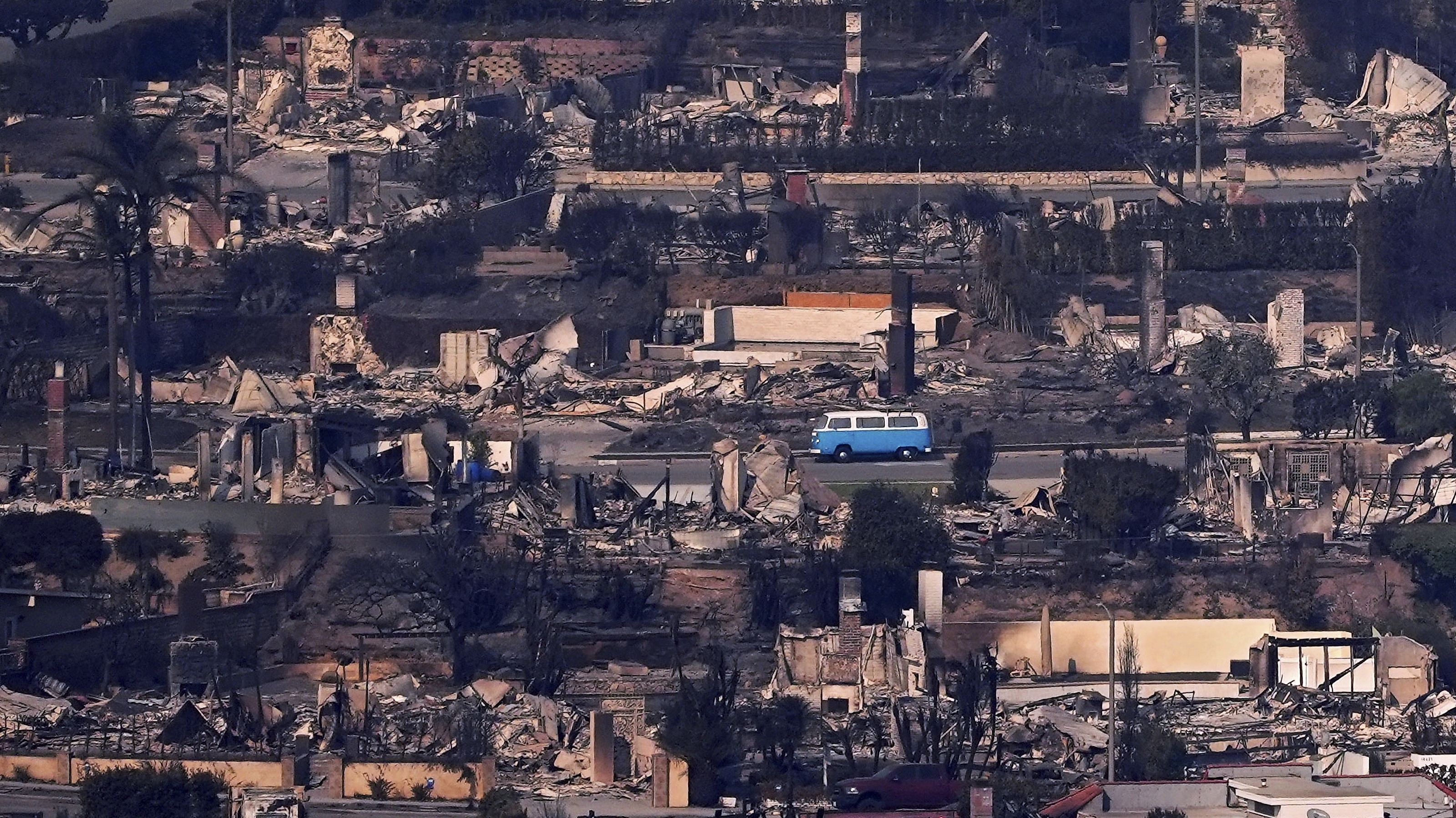 A VW van sits among burned out homes, Jan. 9, in Malibu, Calif.