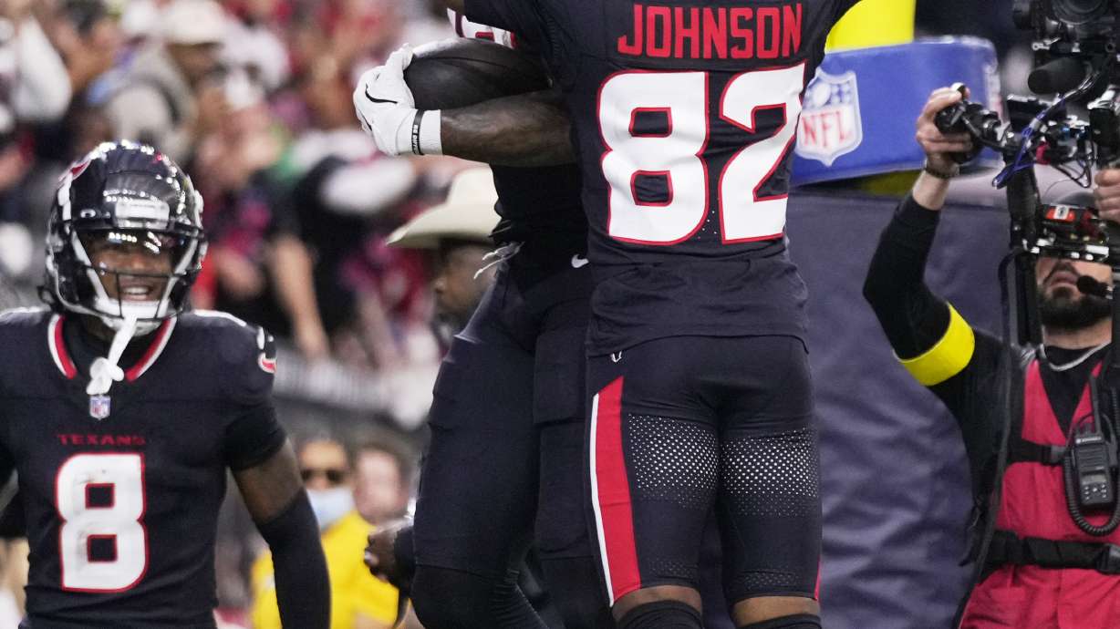 Houston Texans wide receiver Nico Collins, rear, celebrates with Diontae Johnson (82) after scoring a touchdown against the Los Angeles Chargers during the first half of an NFL wild-card playoff football game Saturday, Jan. 11, 2025, in Houston.