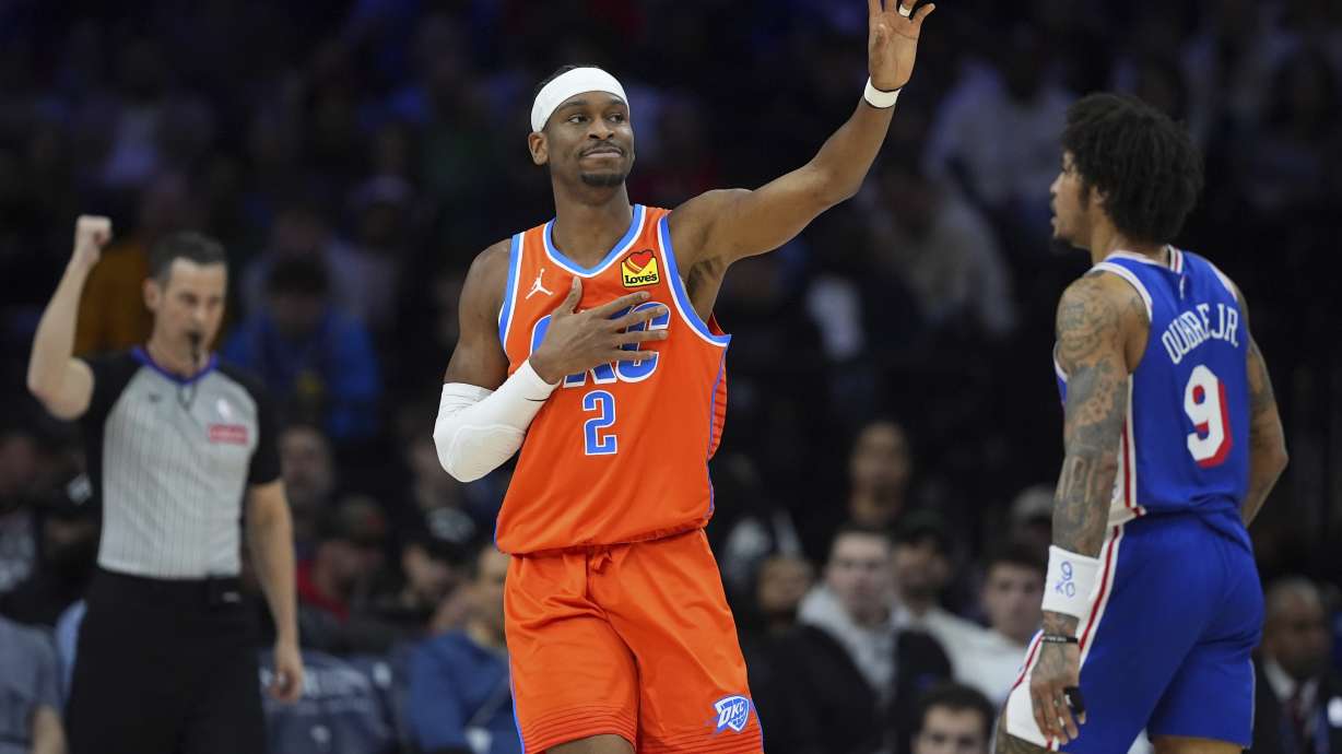 Oklahoma City Thunder's Shai Gilgeous-Alexander, center, reacts after being fouled during the first half of an NBA basketball game against the Philadelphia 76ers, Tuesday, Jan. 14, 2025, in Philadelphia.