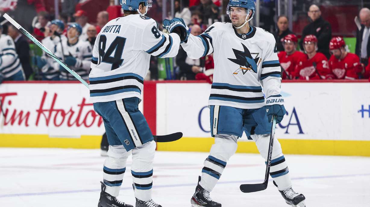 San Jose Sharks defenseman Cody Ceci (4) and San Jose Sharks defenseman Jan Rutta (84) celebrate after a goal to go up in the first period of an NHL hockey game against the Detroit Red Wings Tuesday, Jan. 14, 2025, in Detroit.