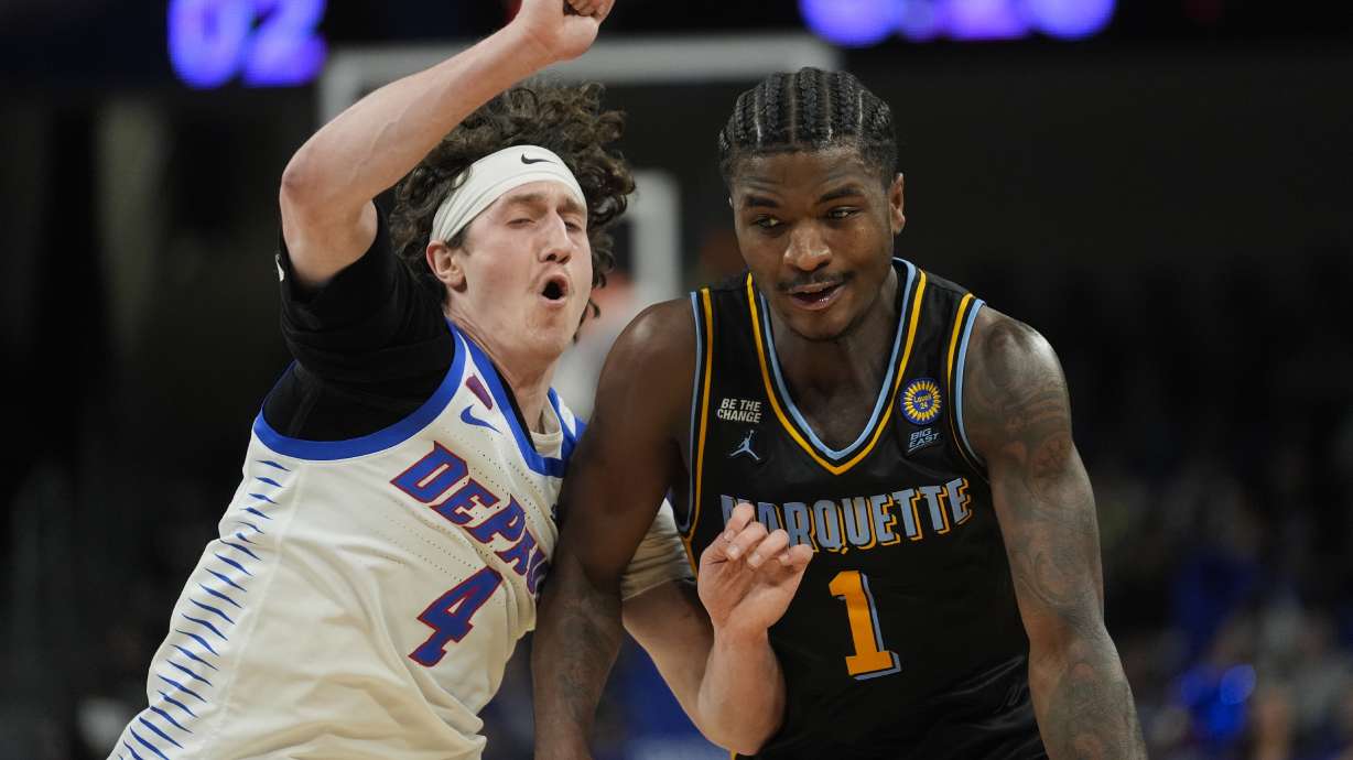 DePaul guard Conor Enright (4) guards Marquette guard Kam Jones (1) during the first half of an NCAA college basketball game Tuesday, Jan. 14, 2025, in Chicago.