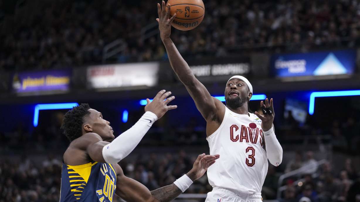 Cleveland Cavaliers guard Caris LeVert (3) grabs a rebound over Indiana Pacers guard Bennedict Mathurin (00) during the second half of an NBA basketball game in Indianapolis, Tuesday, Jan. 14, 2025.