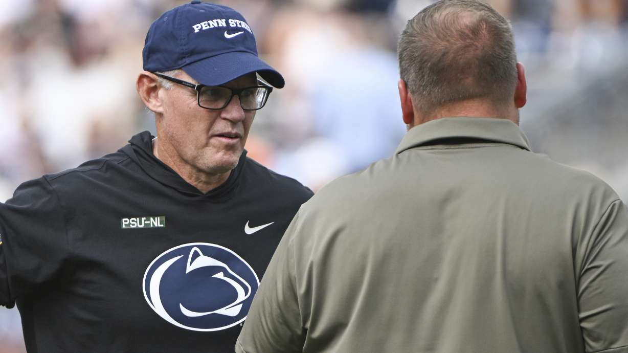 FILE - Penn State defensive coordinator Tom Allen, left, talks with offensive coordinator Andy Kotelnicki before an NCAA college football game against Kent State, Sept. 21, 2024, in State College, Pa.