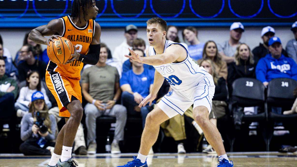 BYU Cougars guard Dallin Hall (30) guards Oklahoma State Cowboys guard Arturo Dean (2) during an NCAA men’s basketball game held at the Marriott Center in Provo on Tuesday, Jan. 14, 2025.