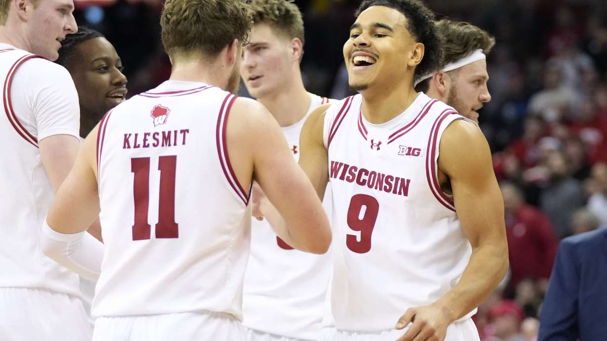 Wisconsin guard Max Klesmit (11) congratulates Wisconsin guard John Tonje (9) on dunking the ball during the first half of an NCAA college basketball game against Ohio State Tuesday, Jan. 14, 2025, in Madison, Wis.