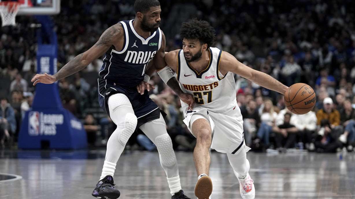 Denver Nuggets guard Jamal Murray (27) works against Dallas Mavericks guard Kyrie Irving (11) in the second half of an NBA basketball game in Dallas, Tuesday, Jan. 14, 2025.