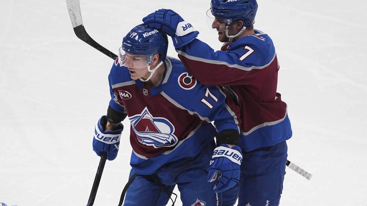 Colorado Avalanche defenseman Devon Toews, right, congratulates center Parker Kelly after he scored a goal in the first period of an NHL hockey game against the New York Rangers Tuesday, Jan. 14, 2025, in Denver.