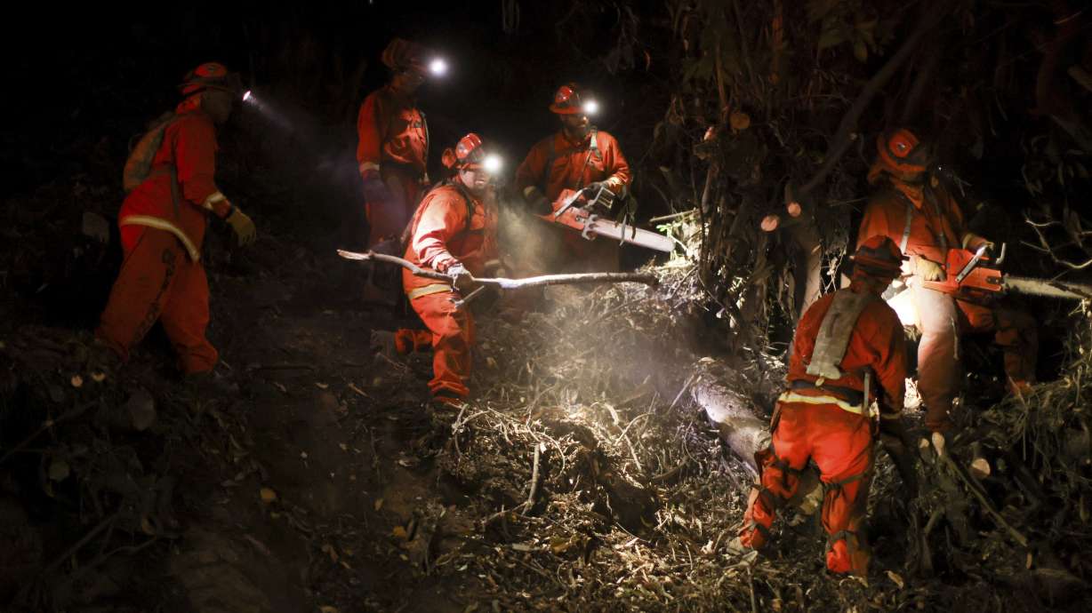 A California Department of Corrections hand crew works containment lines ahead of the Palisades Fire Tuesday in Santa Monica, California.