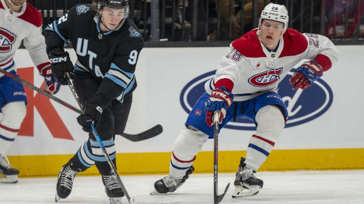 Utah Hockey Club center Clayton Keller (9) races Montreal Canadiens center Christian Dvorak (28) to the puck, during the second period of an NHL hockey game Tuesday, Jan. 14, 2025, in Salt Lake City.