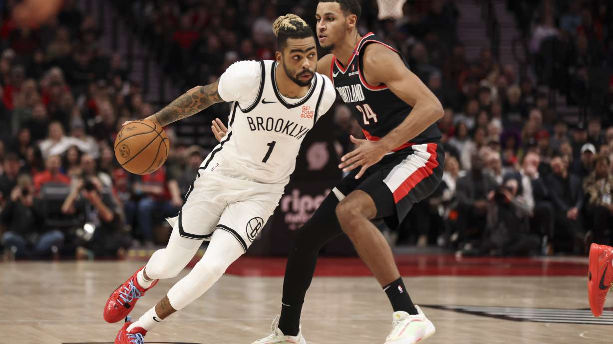 Brooklyn Nets guard D'Angelo Russell (1) brings the ball up court as Portland Trail Blazers forward Kris Murray (24) defends during the first half of an NBA basketball game, Tuesday, Jan. 14, 2025, in Portland, Ore.