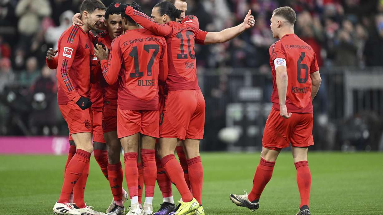 Munich players celebrate Jamal Musiala's goal during the Bundesliga soccer match between Bayern Munich and RB Leipzig at the Allianz Arena, Munich, Germany, Friday Dec. 20, 2024.