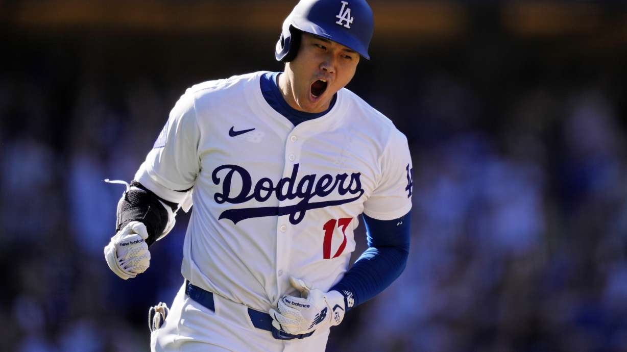 FILE - Los Angeles Dodgers' Shohei Ohtani celebrates as he heads to first for a solo home run during the ninth inning of a baseball game against the Colorado Rockies, Sunday, Sept. 22, 2024, in Los Angeles.