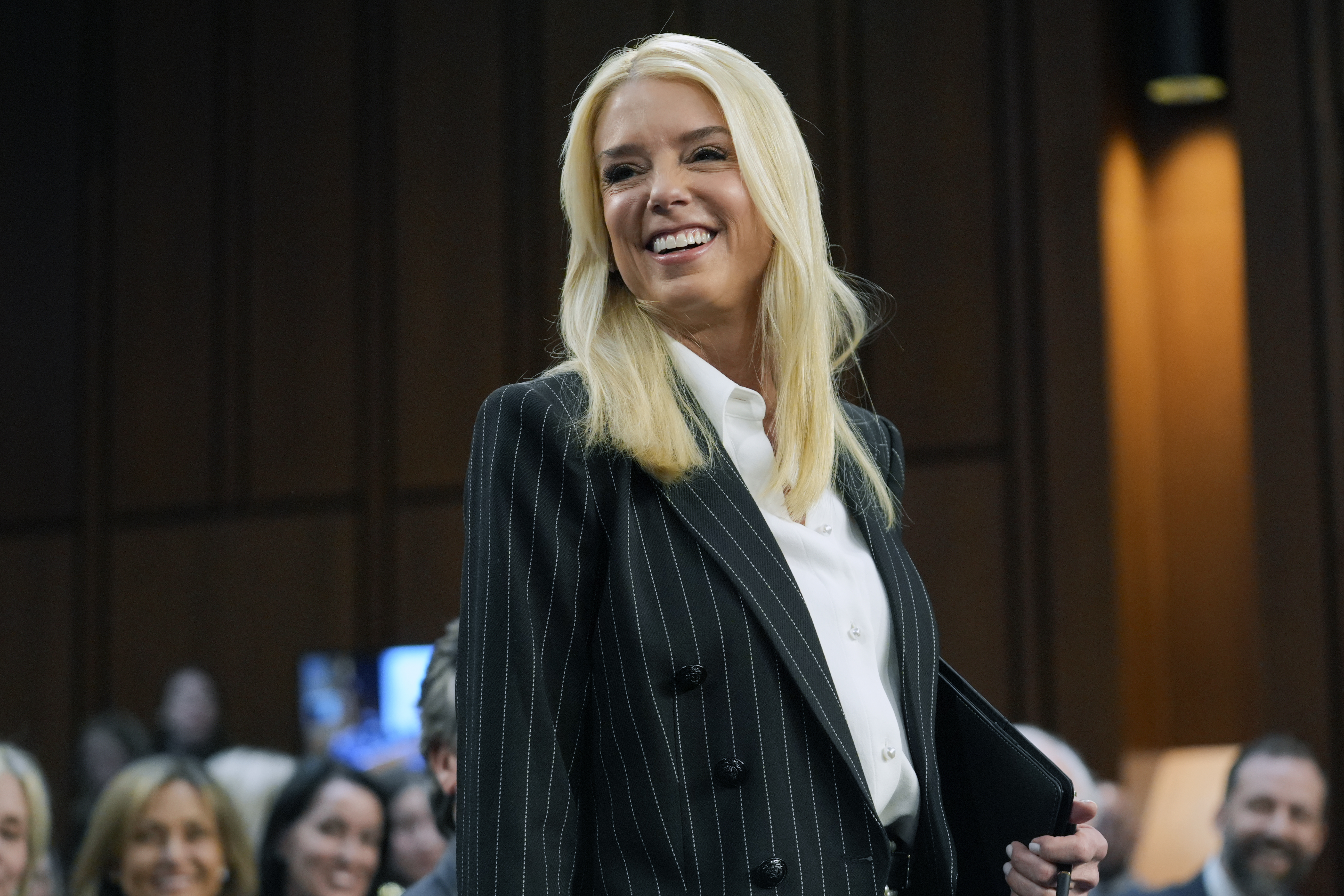 Pam Bondi, President-elect Donald Trump's choice to lead the Justice Department as attorney general, arrives to appear before the Senate Judiciary Committee for her confirmation hearing, at the Capitol in Washington, Wednesday.