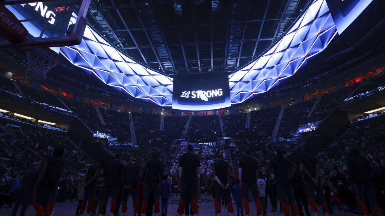 Los Angeles Clippers players stand during a moment of silence for victims of the ongoing California wildfires before an NBA basketball game against the Miami Heat, Monday, Jan. 13, 2025, in Los Angeles.