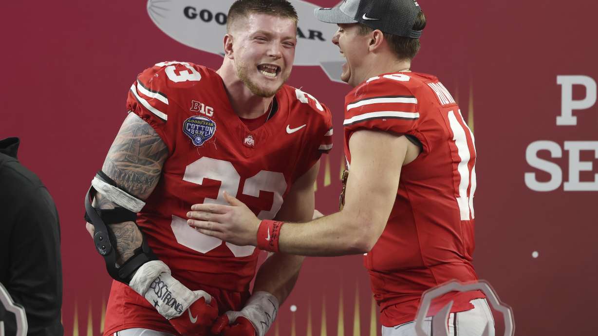 Ohio State defensive end Jack Sawyer, left, and quarterback Will Howard celebrate after the Cotton Bowl College Football Playoff semifinal game against Texas, Friday, Jan. 10, 2025, in Arlington, Texas.
