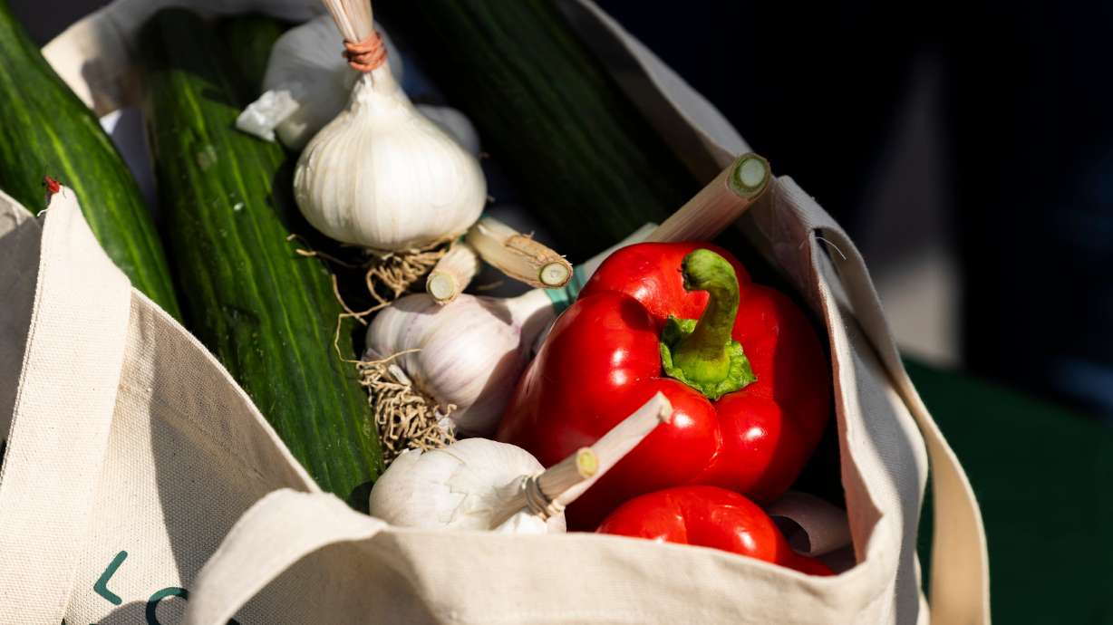 Bell peppers and other produce are displayed in a bag during the launch of the Millcreek Farmers Market at Millcreek Common in Millcreek on Wednesday, July 10, 2024.