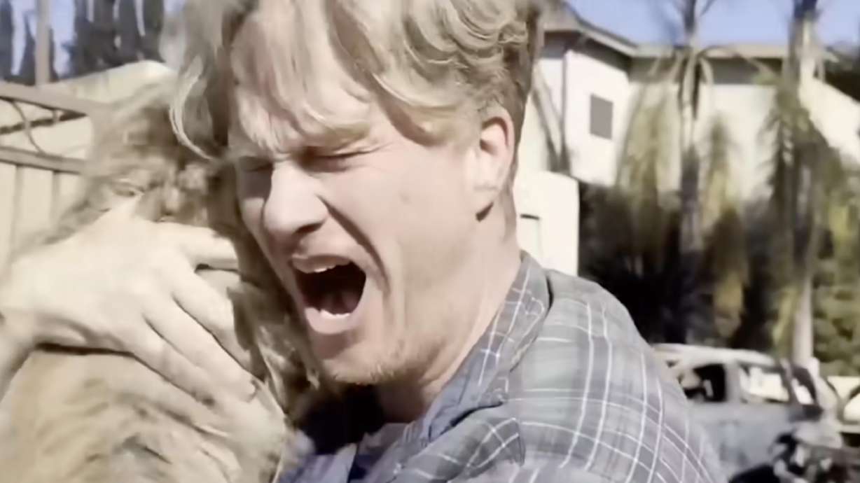 Casey Colvin celebrates after reuniting with his dog, Oreo, who had been lost for days after Colvin's home burned down in the Los Angeles wildfires.