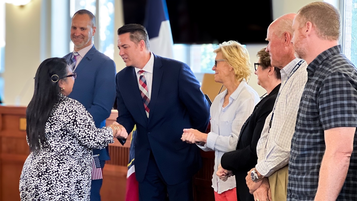 Ava Flores, one of nine people who took the oath of naturalization on Sept. 30, 2024, in Ogden, greets officials at the ceremony. She was a member of Ogden's initial PATH to Citizenship class, to become an annual thing.