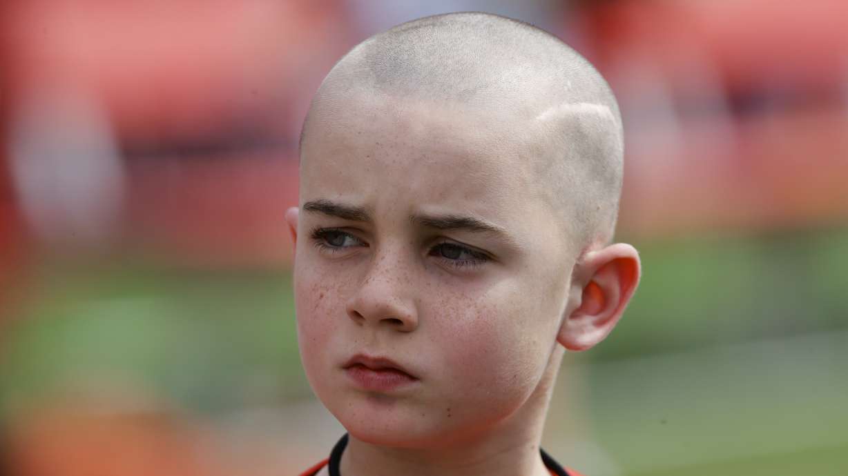 FILE - Cancer survivor Jack Hoffman before delivering a drug-free pledge during the halftime of Nebraska's NCAA college football spring game in Lincoln, Neb., April 12, 2014.