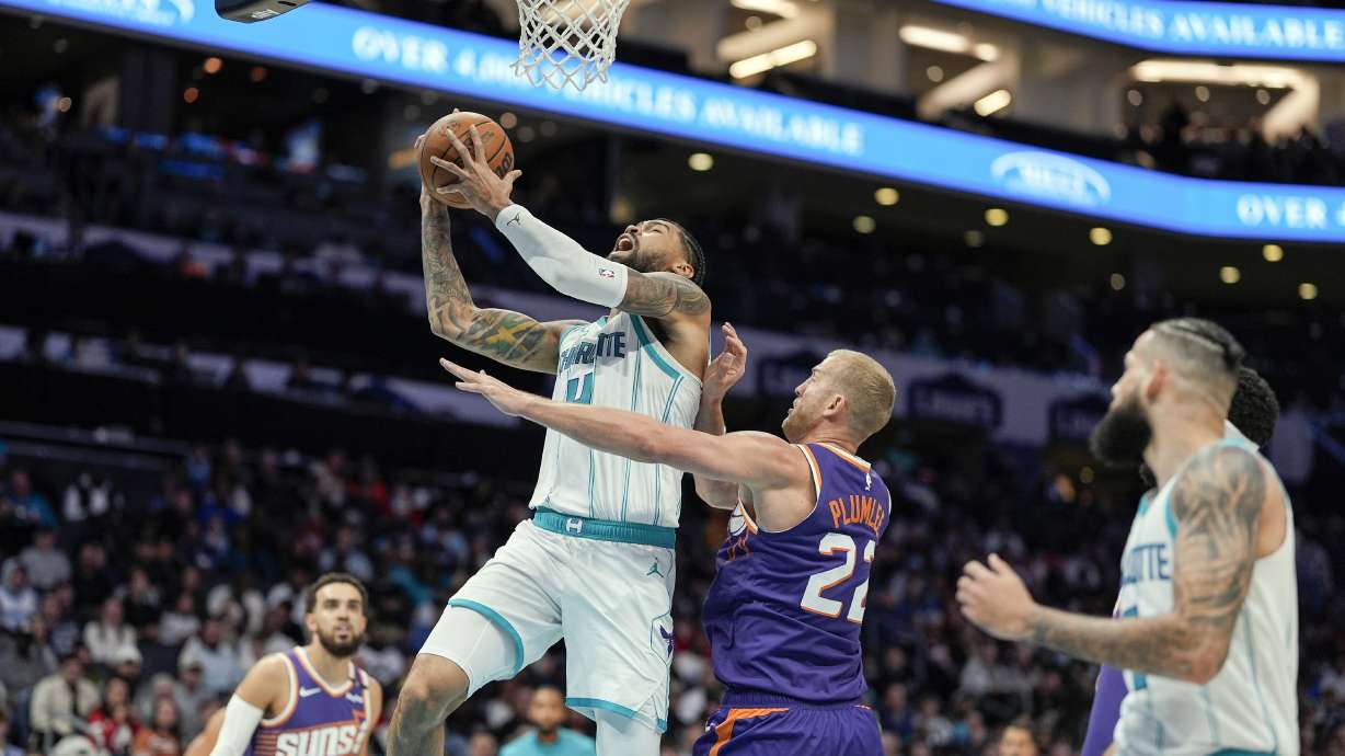Charlotte Hornets center Nick Richards (4) is fouled going up for a shot by Phoenix Suns center Mason Plumlee (22) during the second half of an NBA basketball game in Charlotte, N.C., Tuesday, Jan. 7, 2025.