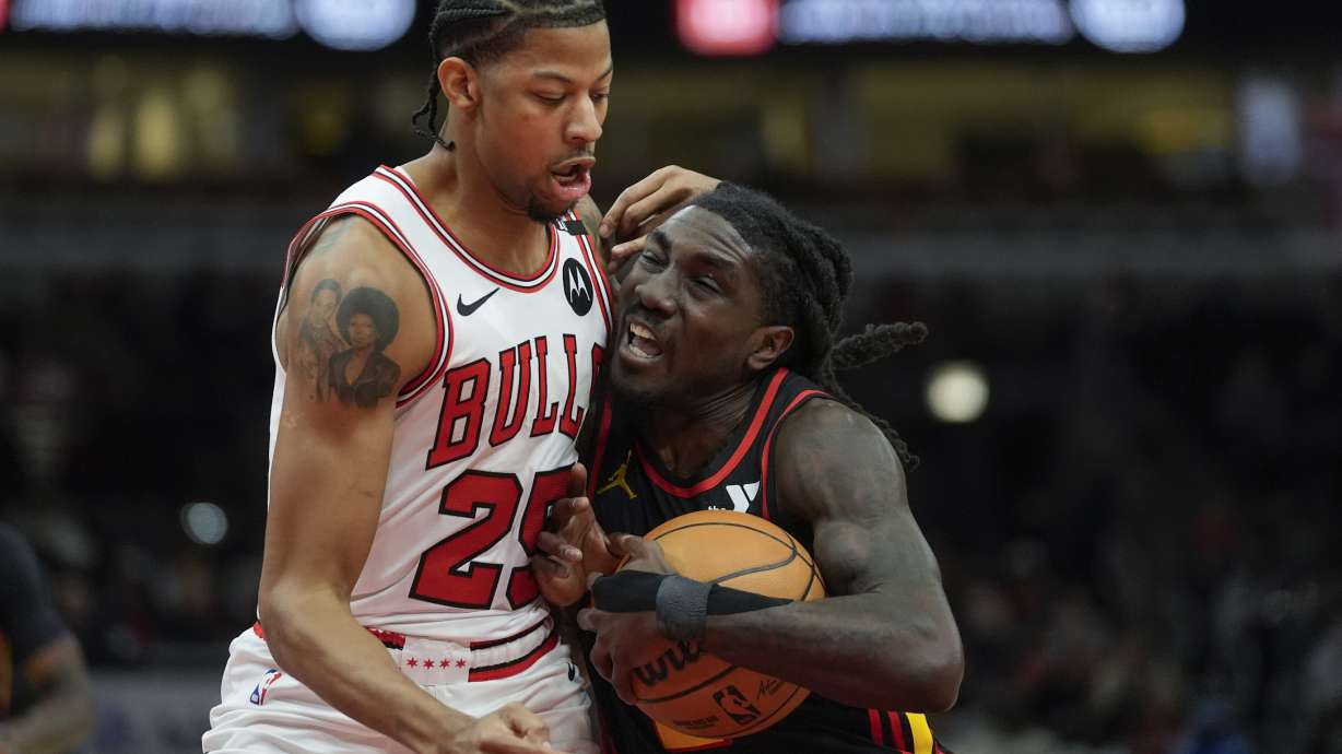 Chicago Bulls forward Dalen Terry (25), left, fouls Atlanta Hawks guard Keaton Wallace (2) during the first half of an NBA basketball game Wednesday, Jan. 15, 2025, in Chicago.