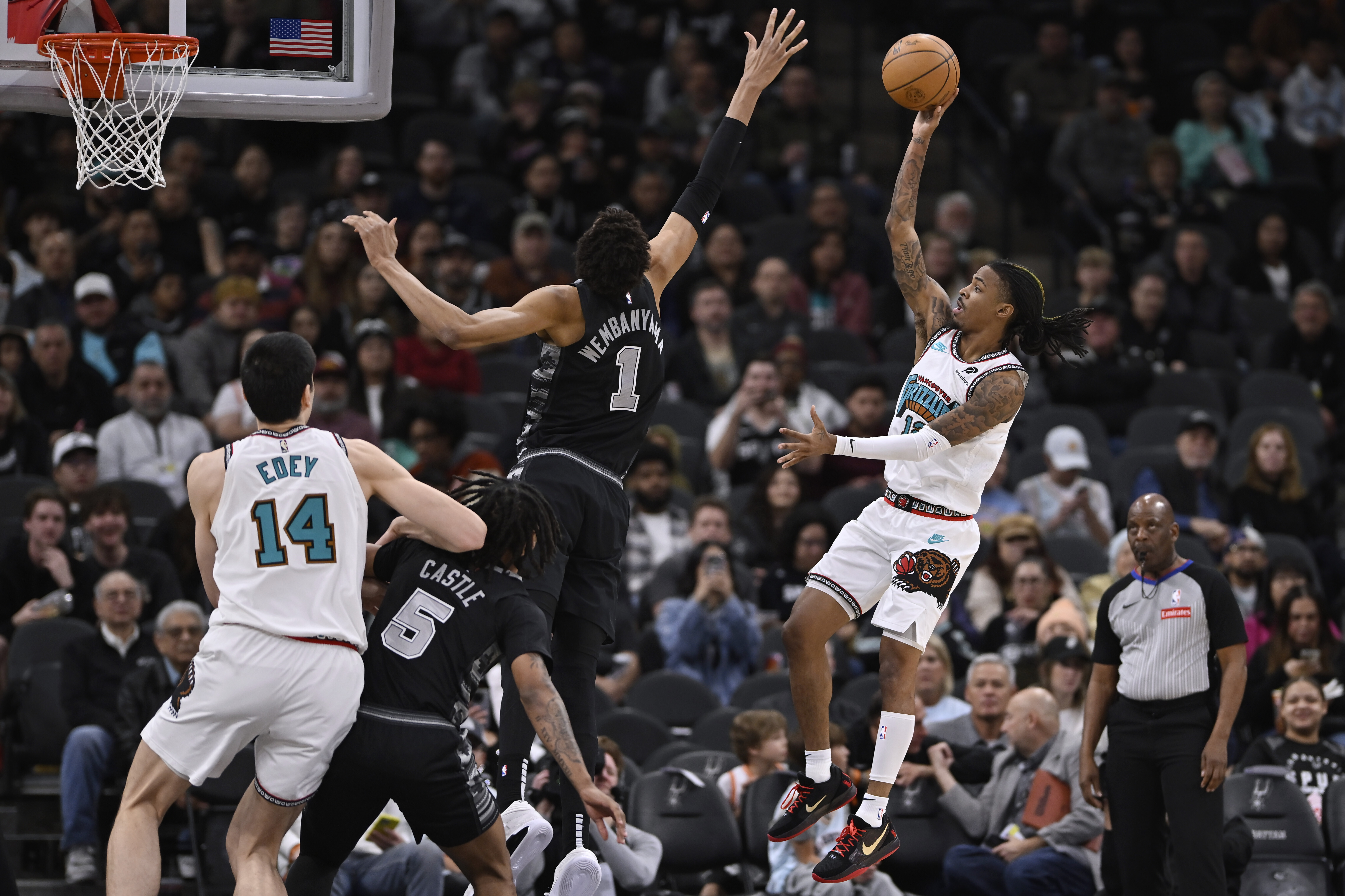 Memphis Grizzlies' Ja Morant, right, shoots against San Antonio Spurs' Victor Wembanyama (1) during the first half of an NBA basketball game, Wednesday, Jan. 15, 2024, in San Antonio.
