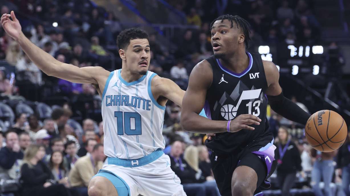 Utah Jazz guard Isaiah Collier (13) dribbles against Charlotte Hornets guard Josh Green (10) during the second half of an NBA basketball game, Wednesday, Jan. 15, 2025, in Salt Lake City.