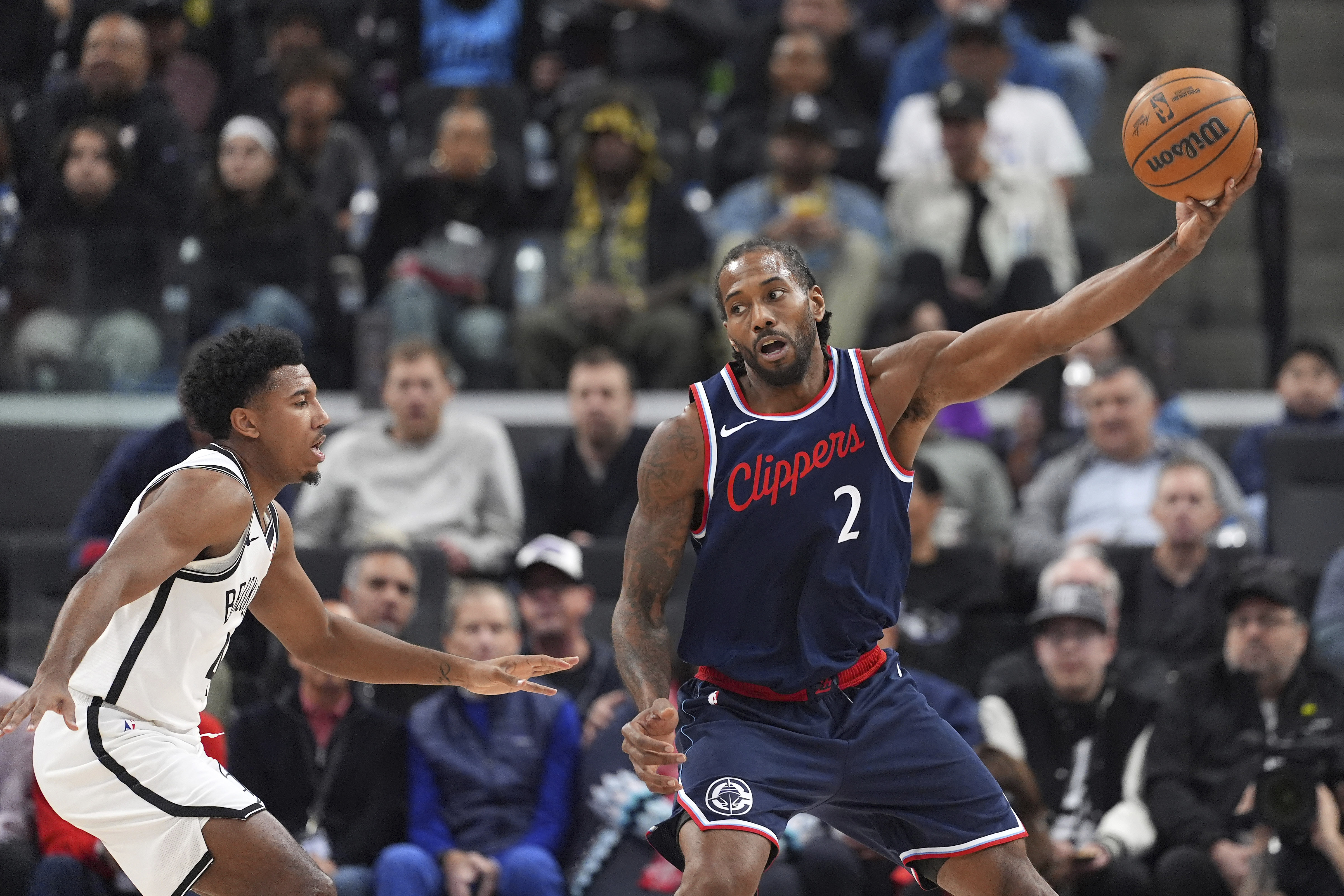 Los Angeles Clippers forward Kawhi Leonard, right, takes a pass as Brooklyn Nets guard Reece Beekman defends during the first half of an NBA basketball game, Wednesday, Jan. 15, 2025, in Inglewood, Calif.
