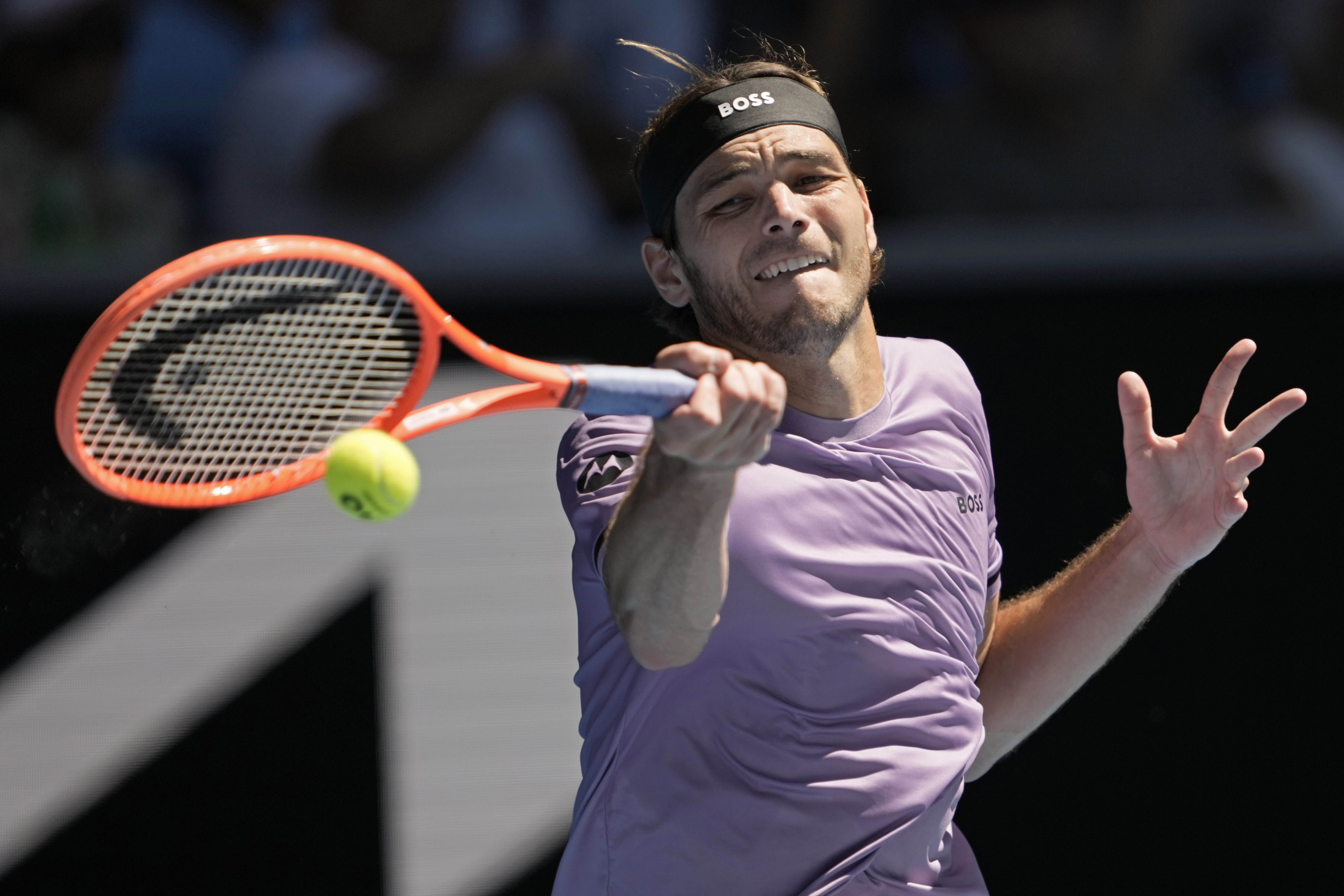 Taylor Fritz of the U.S. plays a forehand return to Cristian Garin of Chile during their second round match at the Australian Open tennis championship in Melbourne, Australia, Thursday, Jan. 16, 2025.
