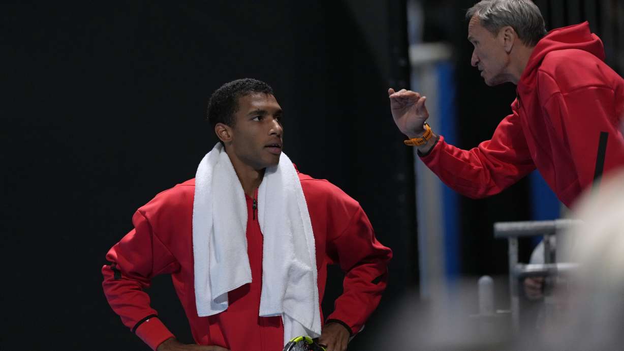 Frederic Fontang, right, coach of Felix Auger-Aliassime of Canada gestures as they talk during a break in the second round match against Alejandro Davidovich Fokina of Spain at the Australian Open tennis championship in Melbourne, Australia, Wednesday, Jan. 15, 2025.