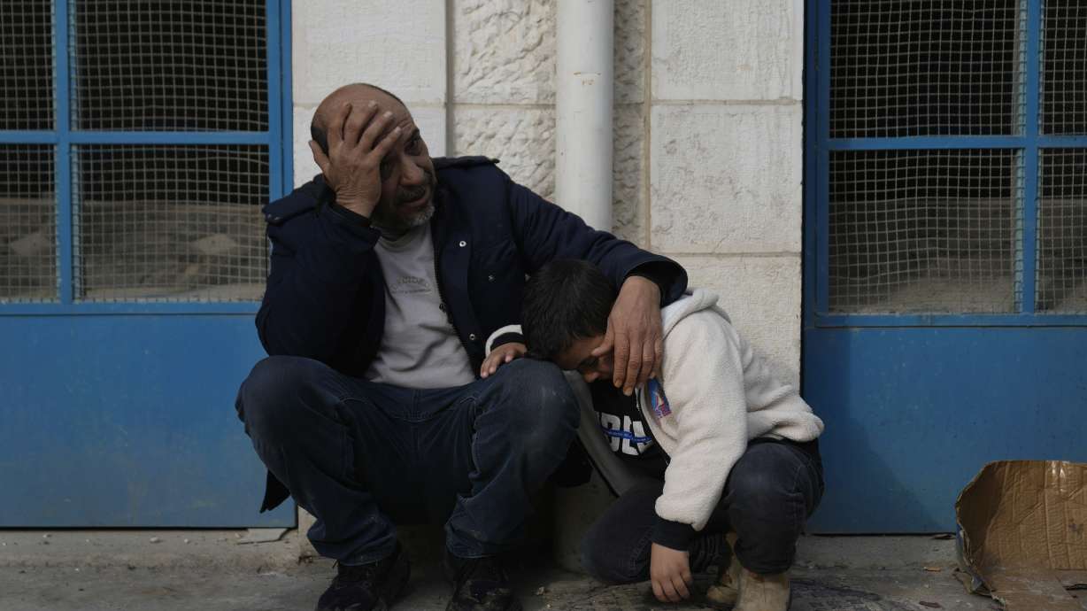 Mourners wait outside the morgue for the funeral of six Palestinians killed during an Israeli airstrike on Wednesday, in the West Bank refugee camp of Jenin Thursday. Israel says a last-minute dispute with Hamas is holding up approval of a ceasefire.
