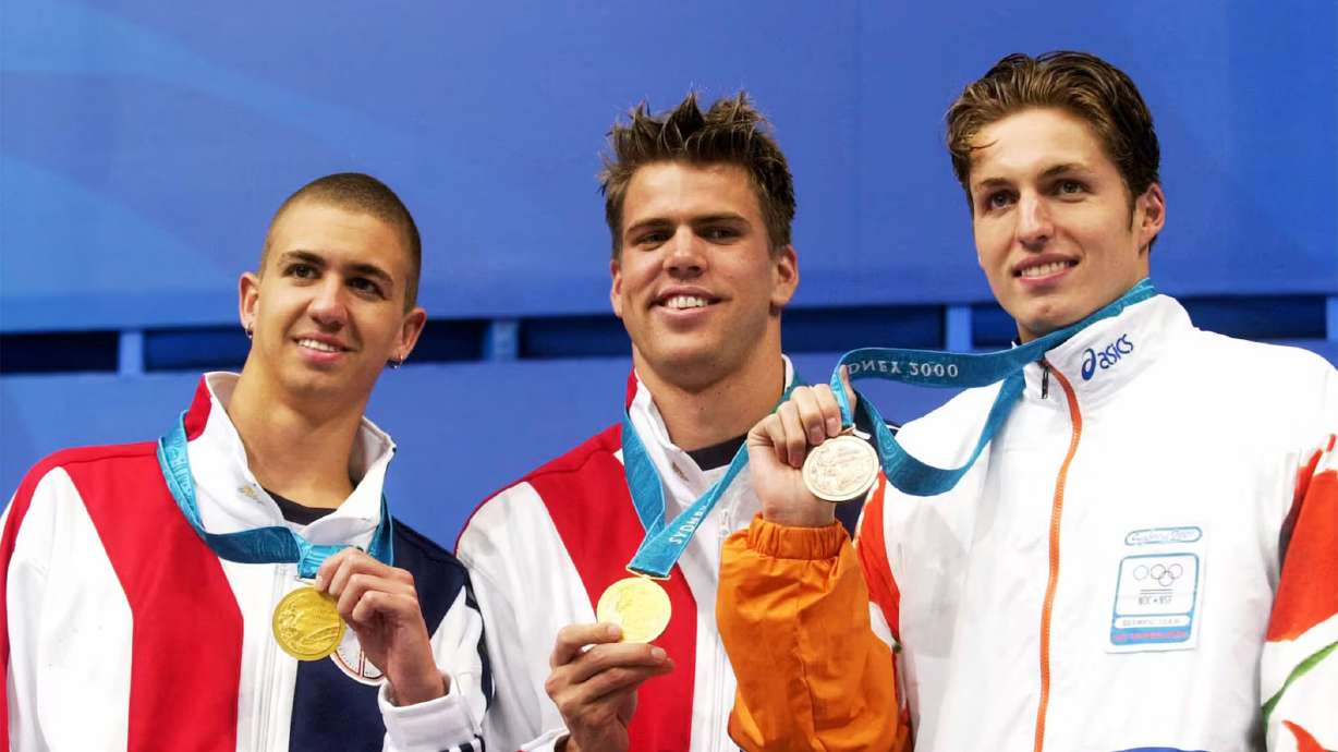 U.S. swimmers Anthony Ervin, left, and Gary Hall Jr., center, who tied for the gold medal in the men's 50-meter freestyle, stand with Dutch swimmer Pieter van den Hoogenband, right, who won the bronze medal Sept. 22, 2000, at the Sydney International Aquatic Center during the Summer Olympics in Sydney. Hall lost his medals in the California wildfires.