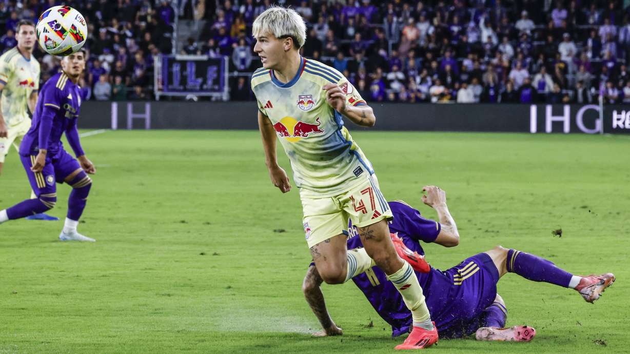 FILE - New York Red Bulls defender John Tolkin (47) gets ball away from Orlando City midfielder Dagur Dan Þórhallsson, right, during the first half of an MLS Eastern Conference final soccer match, Saturday, Nov. 30, 2024, in Orlando, Fla.