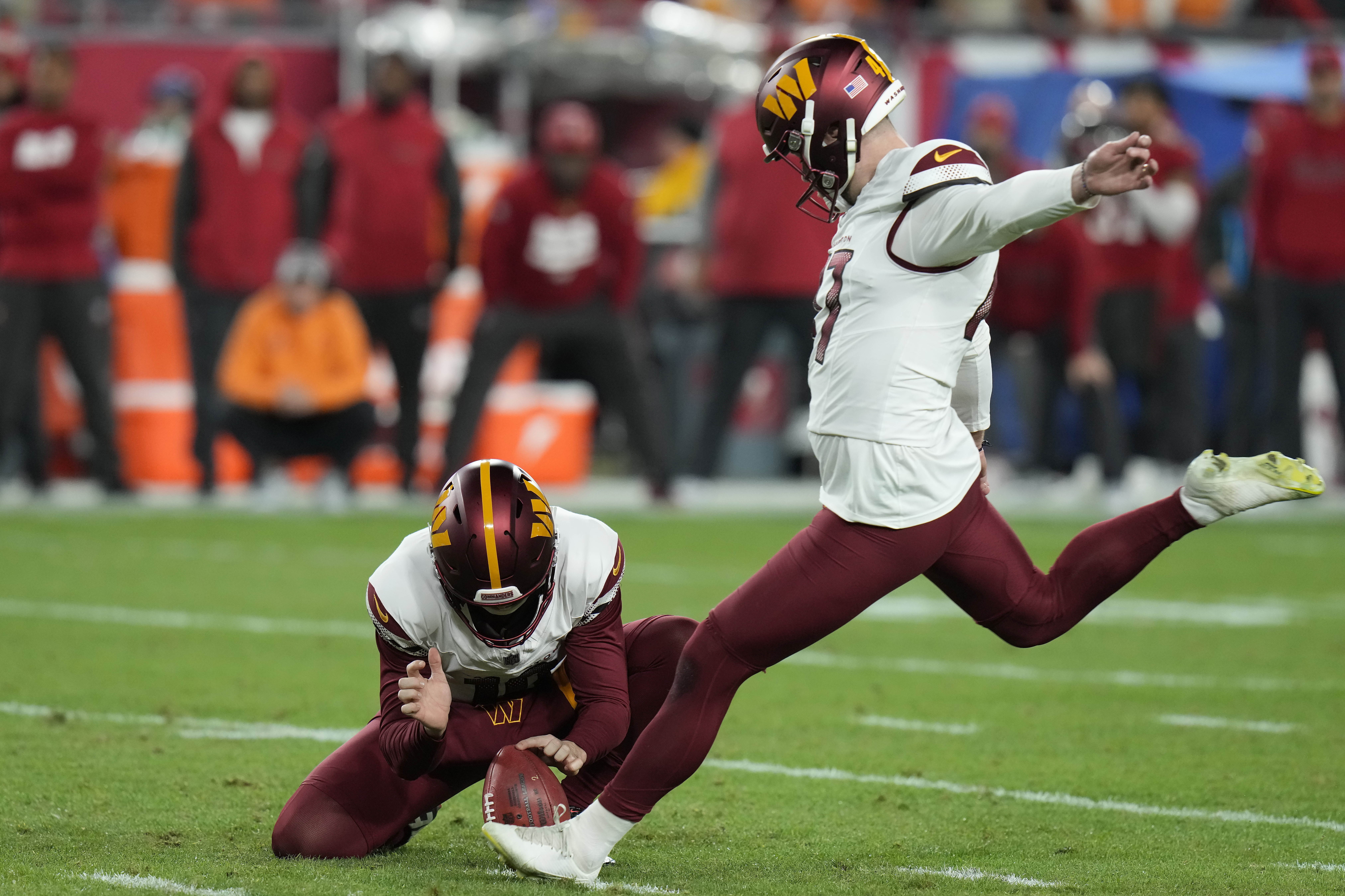 FILE - Washington Commanders place kicker Zane Gonzalez, right, kicks the game winning field goal from the hold of Tress Way during the second half of an NFL wild-card playoff football game against the Tampa Bay Buccaneers in Tampa, Fla., Jan. 12, 2025.