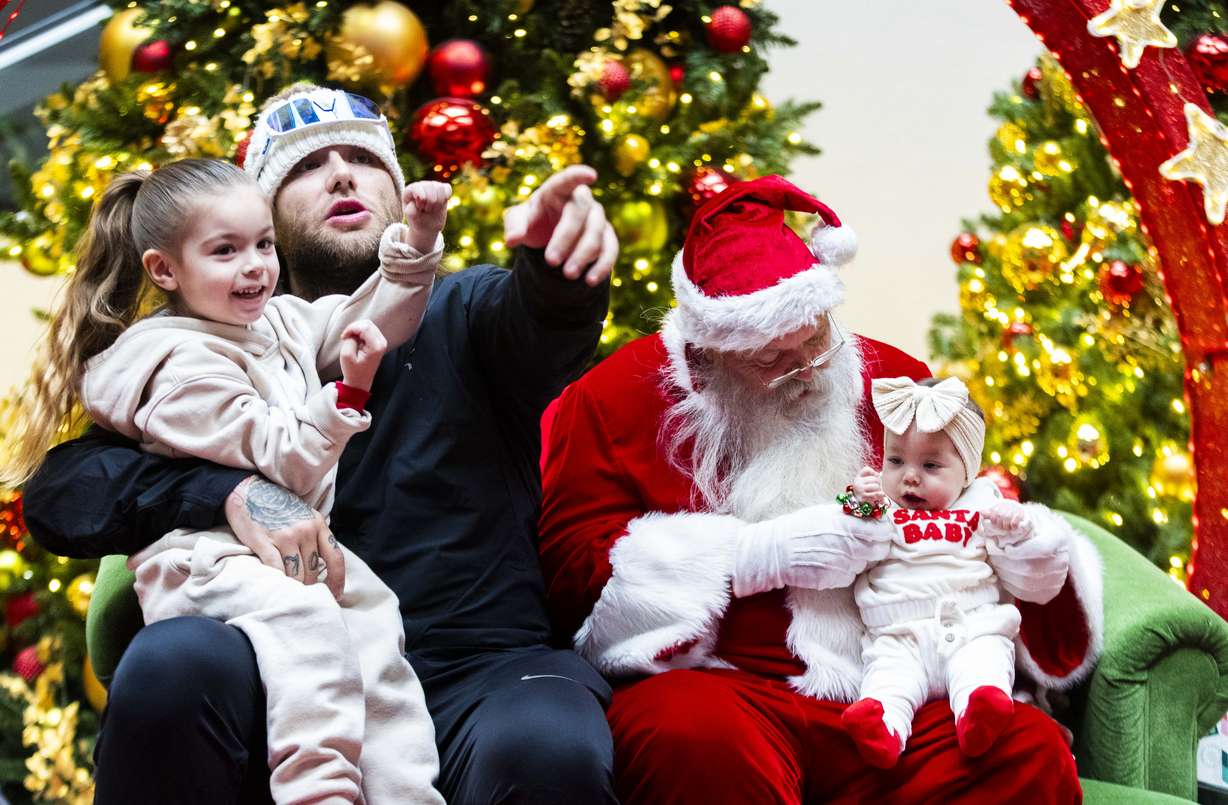 Chase Drake holds his son, Kayden Kent, 4, on his knee and points to the camera while Santa Rich holds Drake’s daughter Kaleesia Kent, on a Sensory Sunday at the Layton Hills Mall in Layton on Dec. 15, 2024. Sensory Sundays are Sundays through Dec. 15 at the Layton Hills Mall, with dedicated quiet hours for children and families who may benefit from a sensory-friendly and comfortable holiday experience with Santa.