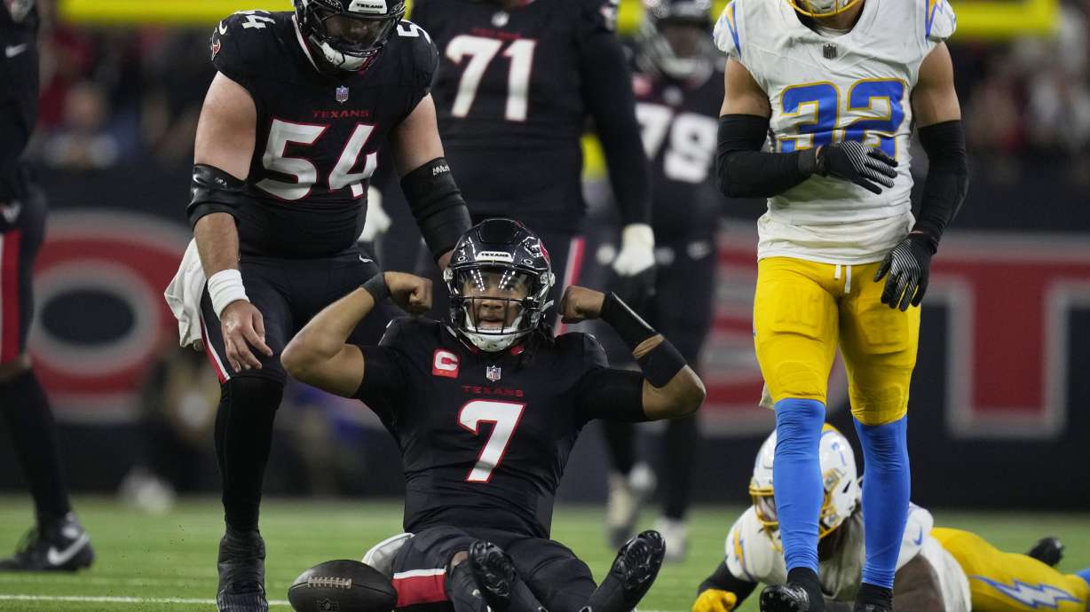 Houston Texans quarterback C.J. Stroud (7) reacts after nearly rushing for a first down as Los Angeles Chargers safety Alohi Gilman (32) defends during the second half of an NFL wild-card playoff football game Saturday, Jan. 11, 2025, in Houston.