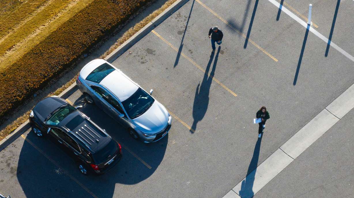 Employees walk toward their cars on the state of Utah's Taylorsville campus on Jan. 10. Gov. Spencer Cox on Thursday stopped short of saying whether he's going to order state government workers to return to the office full time.