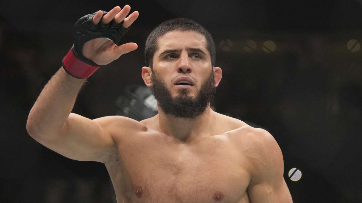 FILE - Islam Makhachev of Russia celebrates after he beats Alex Volkanovski of Australia in the UFC lightweight championship fight during UFC 294, at the Ethihad Arena in Abu Dhabi, United Arab Emirates, Oct. 21, 2023.