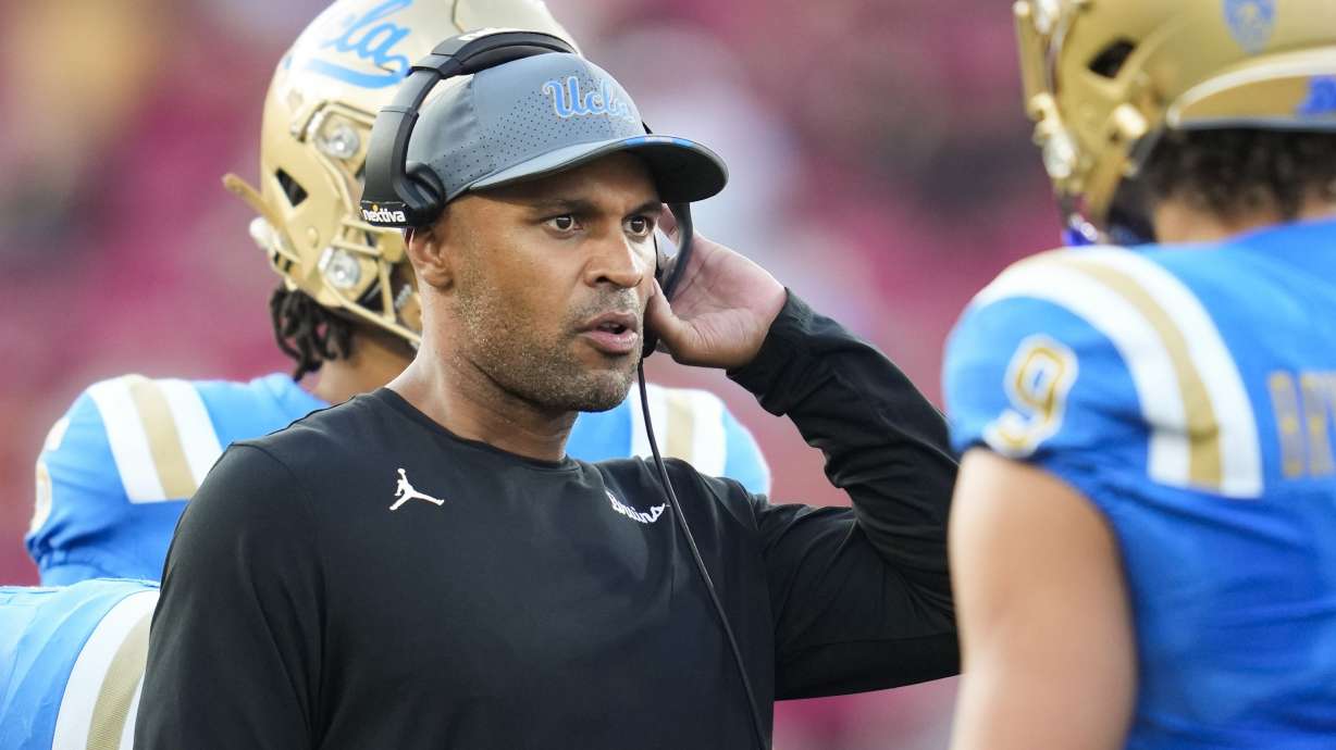 FILE - UCLA defensive coordinator D'Anton Lynn talks with linebacker Choe Bryant-Strother (9) during a timeout during the second half of an NCAA college football game against Southern Californian Los Angeles, Saturday, Nov. 18, 2023.