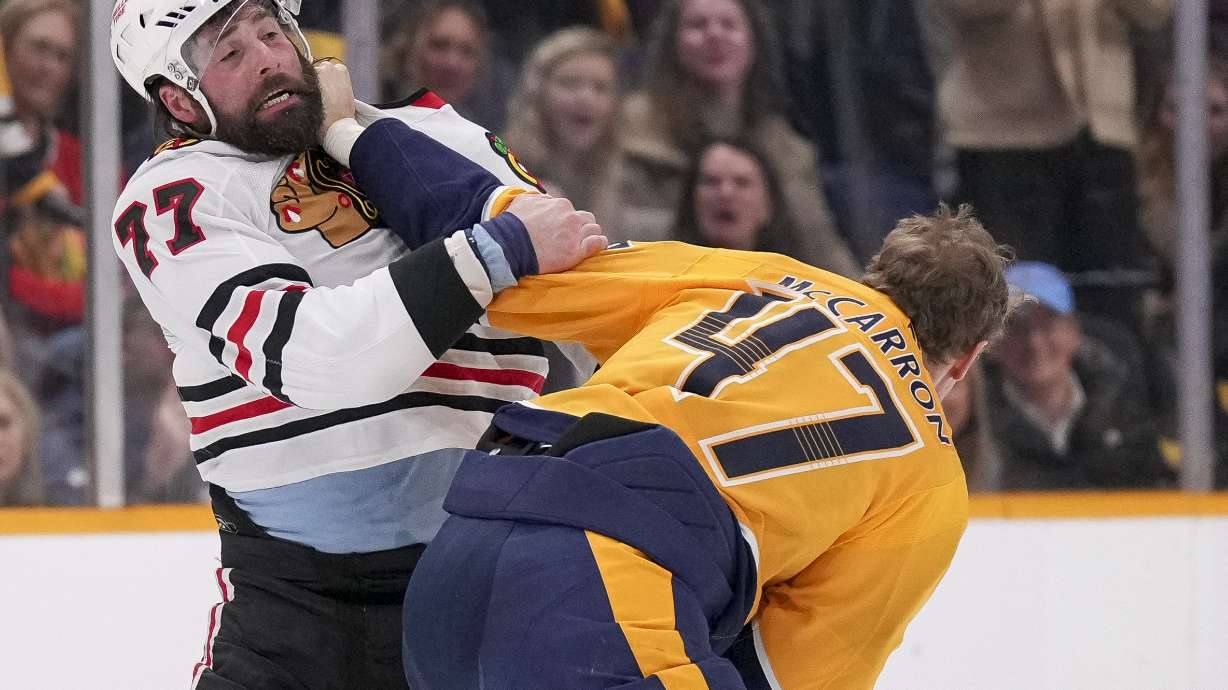 Chicago Blackhawks left wing Patrick Maroon (77) fights with Nashville Predators right wing Michael McCarron (47) during the first period of an NHL hockey game Thursday, Jan. 16, 2025, in Nashville, Tenn.