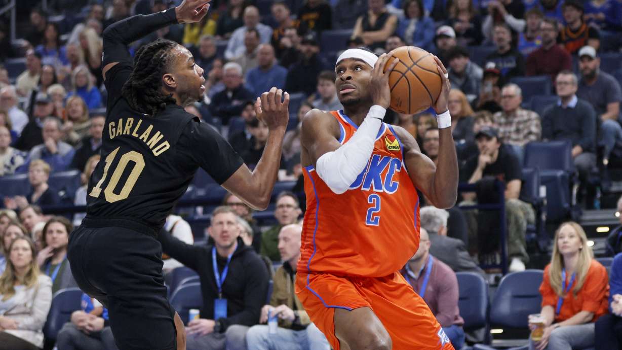 Oklahoma City Thunder guard Shai Gilgeous-Alexander (2) looks to shoot against Cleveland Cavaliers guard Darius Garland (10) during the first half of an NBA basketball game, Thursday, Jan. 16, 2025, in Oklahoma City.