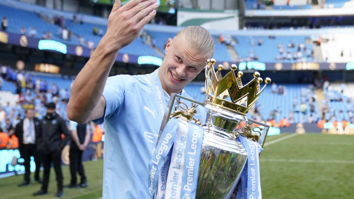 FILE -Manchester City's Erling Haaland celebrates with the Premier League trophy after the English Premier League soccer match between Manchester City and West Ham United at the Etihad Stadium in Manchester, England, May 19, 2024.