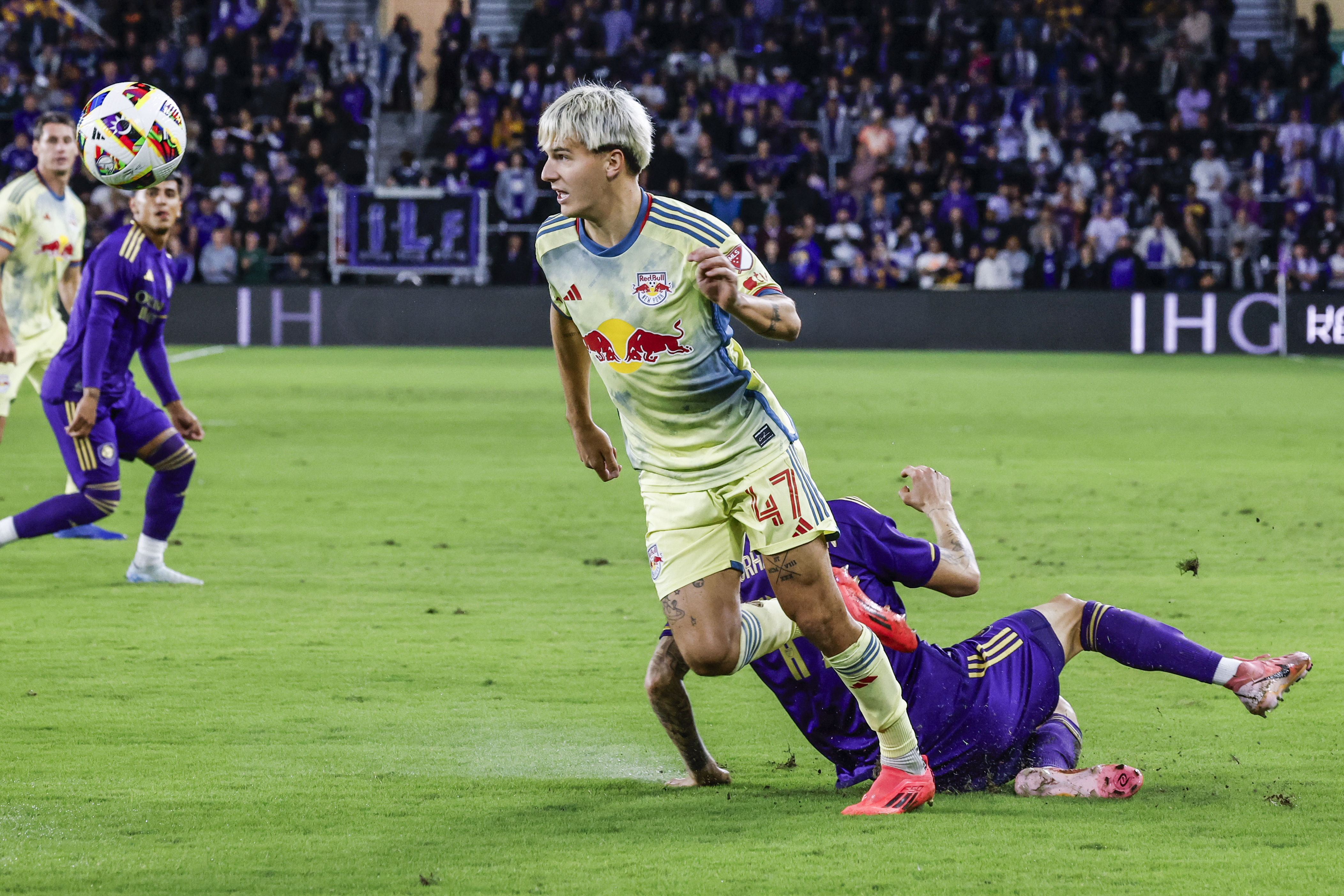 FILE - New York Red Bulls defender John Tolkin (47) gets ball away from Orlando City midfielder Dagur Dan Þórhallsson, right, during the first half of an MLS Eastern Conference final soccer match, Saturday, Nov. 30, 2024, in Orlando, Fla.