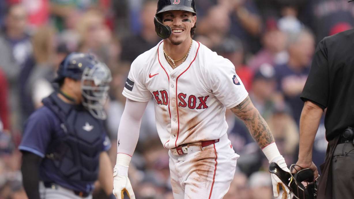 FILE - Boston Red Sox outfielder Jarren Duran, center, smiles after scoring on a Tampa Bay Rays error in the third inning of a baseball game Sunday, Sept. 29, 2024, in Boston.