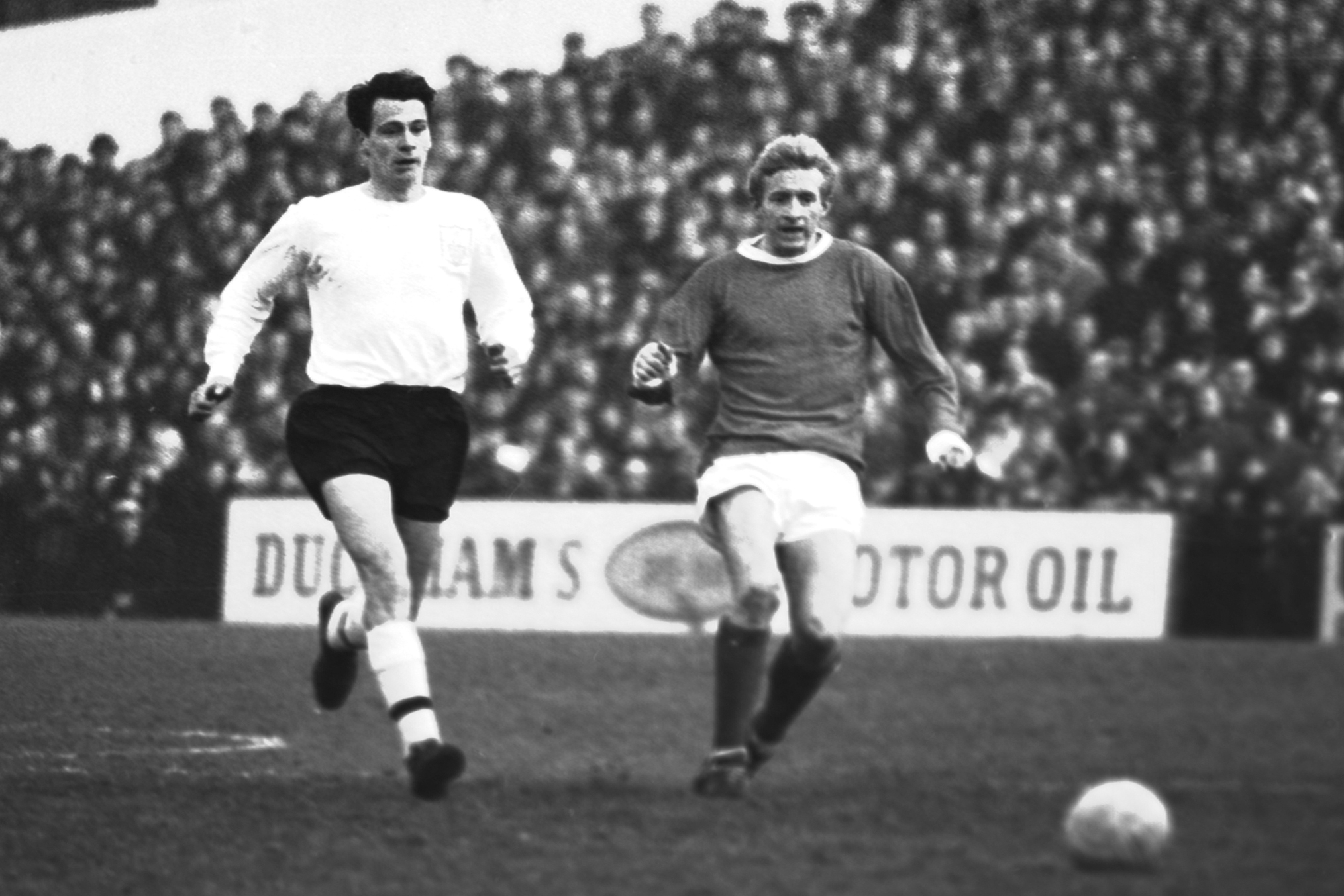 Manchester United's Denis Law, right, and Fulham's Bobby Robson give chase during their an English first division soccer match at Craven Cottage in London, Jan. 15, 1966.