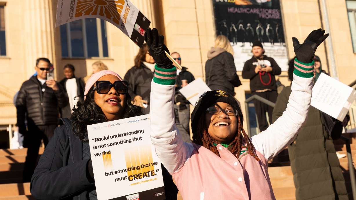 Candyce Fly Lee, left, and Treshain Elerson, sing "Lean on Me" during a rally in honor of Martin Luther King Jr. in Salt Lake City on Jan. 15, 2024.