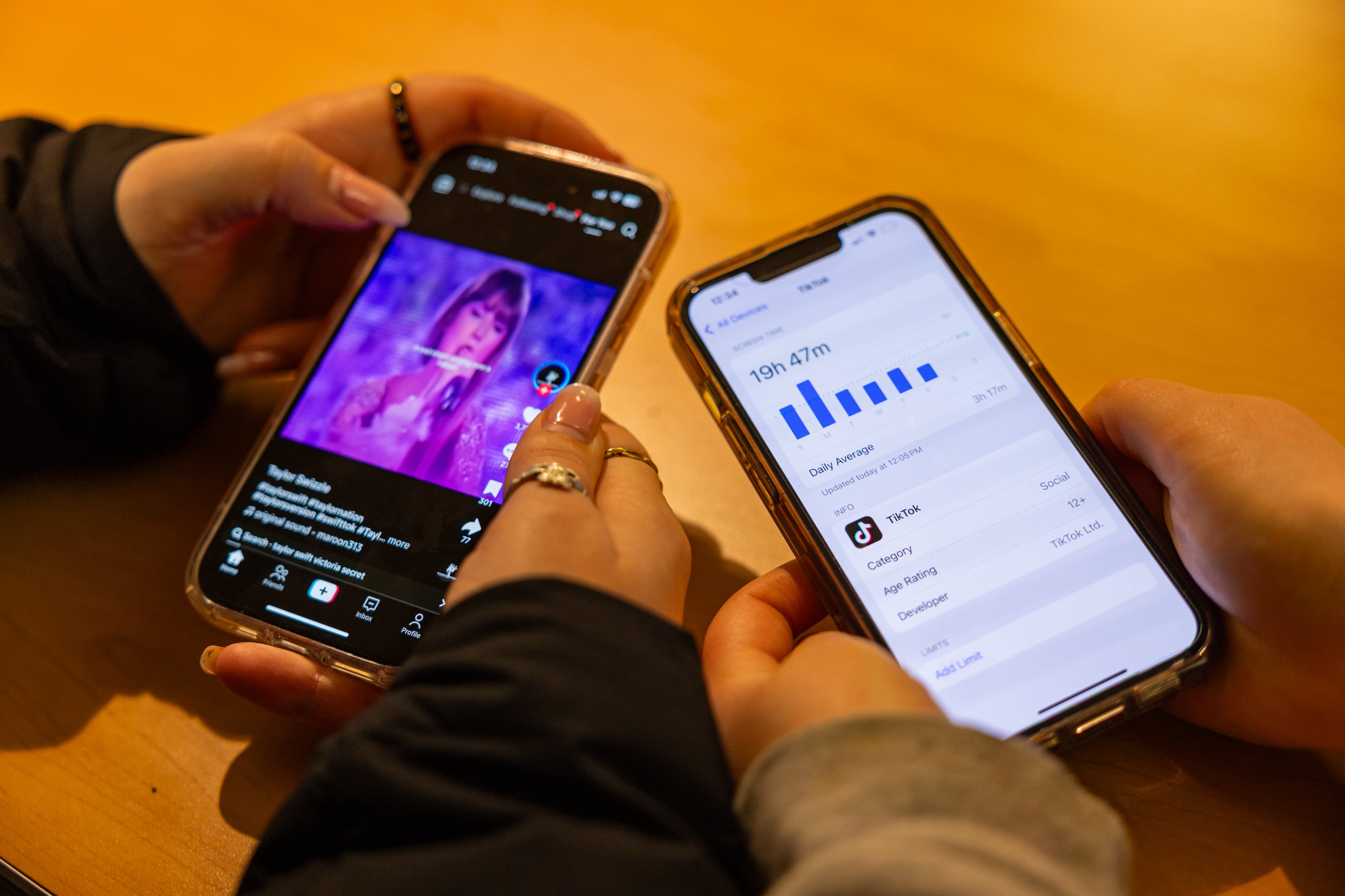 University of Utah freshman Finley Hawkins, left, demonstrates scrolling through videos on TikTok as University of Utah freshman Mae Rathbun, right, displays her weekly screen time on TikTok at the University Union at the University of Utah in Salt Lake City on Friday.