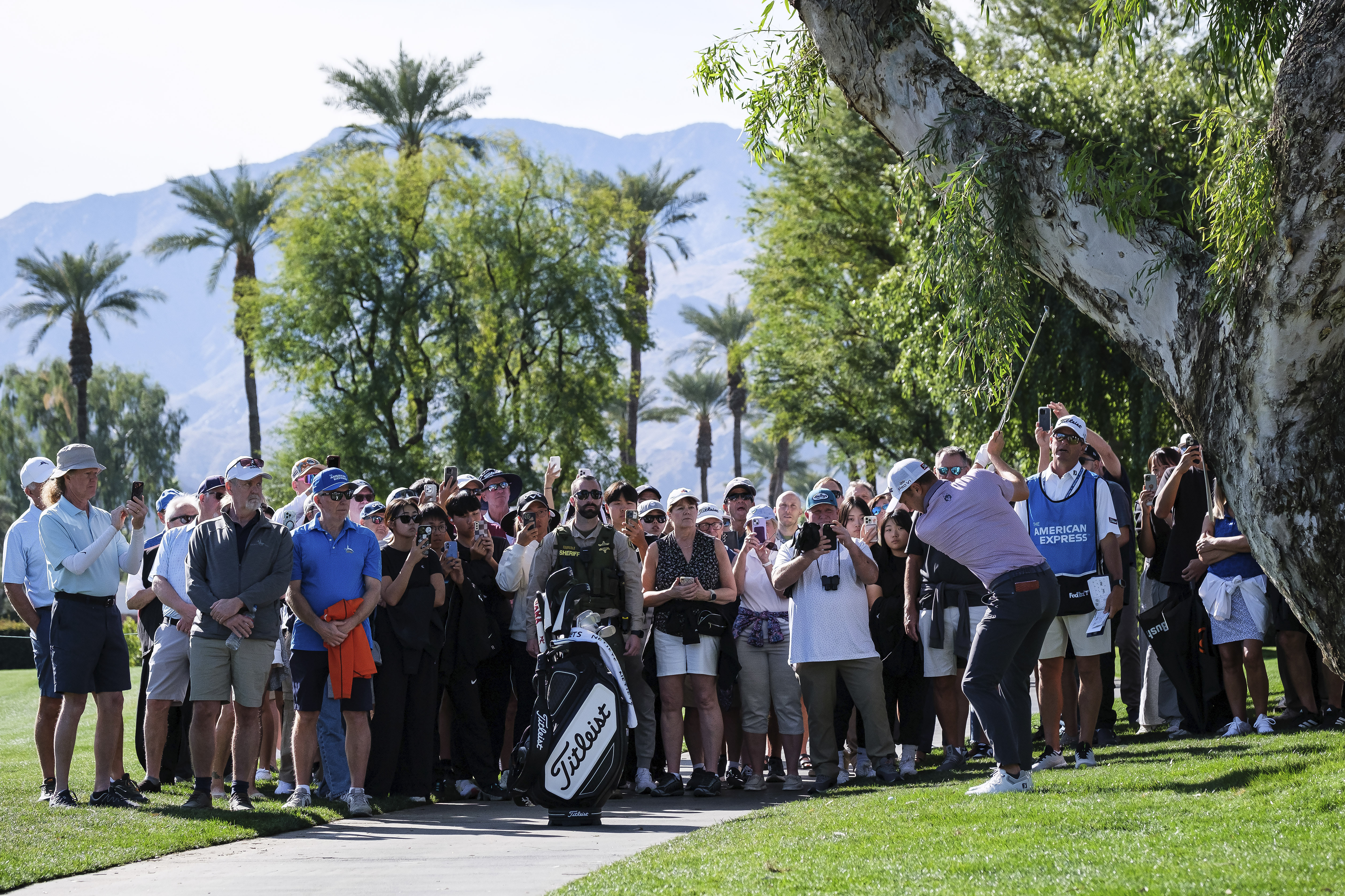 Fans watch as Justin Thomas hits to the fourth fairway at La Quinta Country Club Course during the first round of the American Express golf tournament in La Quinta, Calif., Thursday, Jan. 16, 2025.