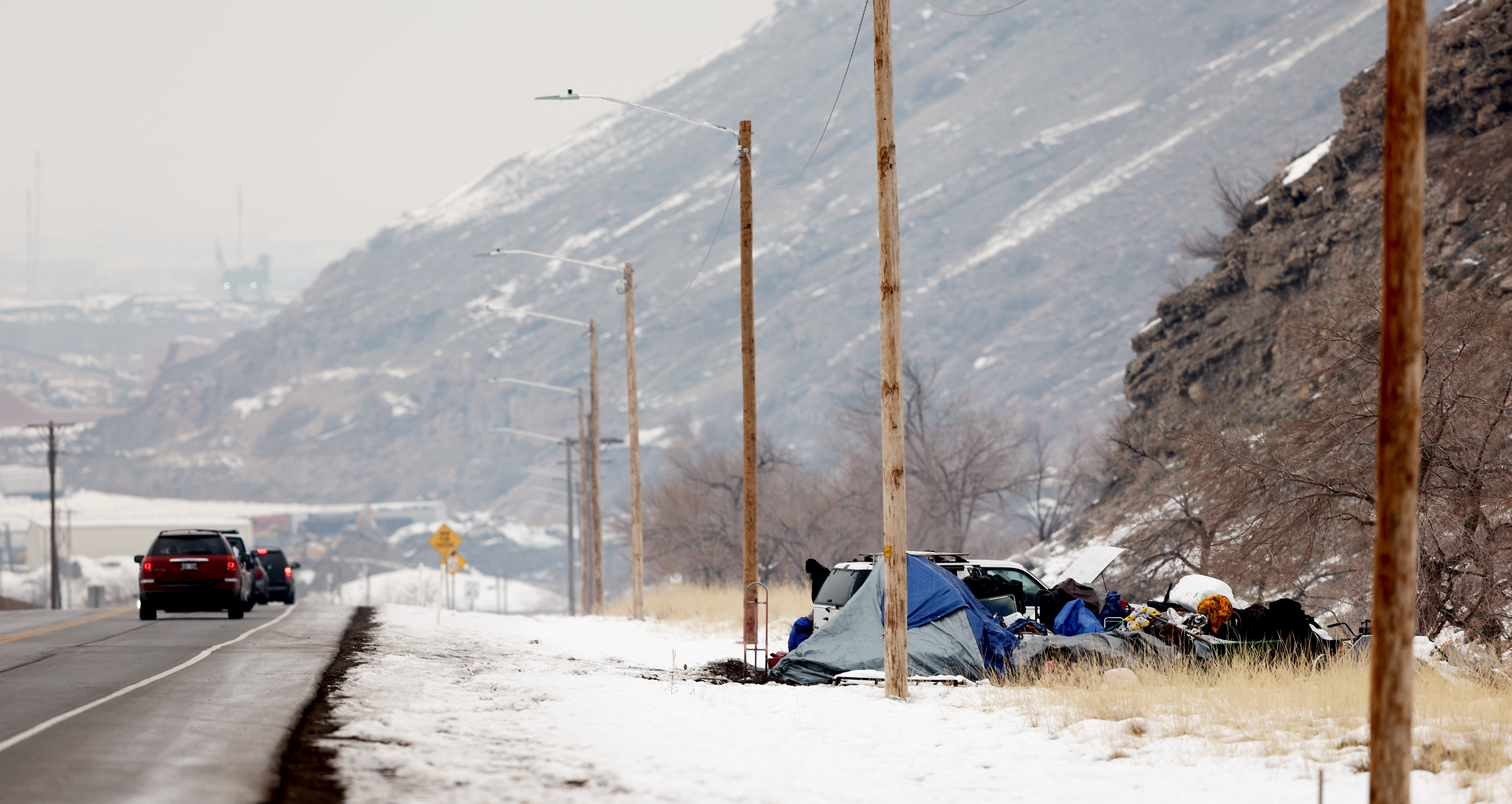 Cars drive past a homeless camp on the side of Victory Road in Salt Lake City on Tuesday, Dec. 20, 2022. Medical professionals from University of Utah Hospital warned Friday that the danger of developing frostbite is expected to increase in the next week.