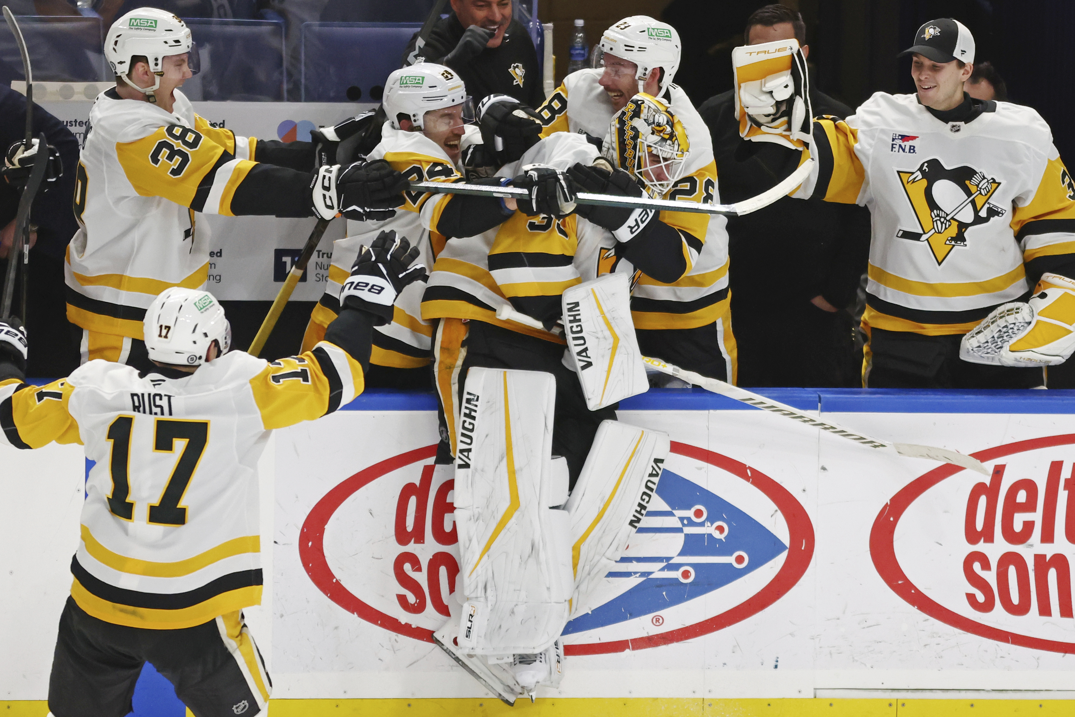 Pittsburgh Penguins goaltender Alex Nedeljkovic, center, celebrates with teammates after scoring during the third period of an NHL hockey game against the Buffalo Sabres, Friday, Jan. 17, 2025, in Buffalo, N.Y.